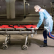 A health worker takes a gurney away after leaving a patient on the train.